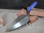 A Faithfull trowel with a polished steel blade and an ergonomic handle, for applying and finishing mortar, plaster, and adhesive.