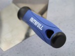 A Faithfull trowel with a polished steel blade and an ergonomic handle, for applying and finishing mortar, plaster, and adhesive.