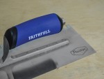 A Faithfull notched tile trowel with 115mm notches for combing adhesive on floors and walls, ensuring even coverage beneath tiles.