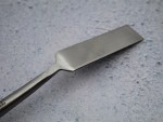 A Faithfull trowel with a polished steel blade and an ergonomic handle, for applying and finishing mortar, plaster, and adhesive.