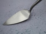 A Faithfull trowel with a polished steel blade and an ergonomic handle, for applying and finishing mortar, plaster, and adhesive.