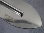 A Faithfull trowel with a polished steel blade and an ergonomic handle, for applying and finishing mortar, plaster, and adhesive.