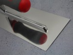 A Faithfull trowel with a polished steel blade and an ergonomic handle, for applying and finishing mortar, plaster, and adhesive.