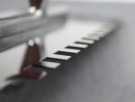 A Faithfull notched tile trowel with 10mm notches for combing adhesive on floors and walls, ensuring even coverage beneath tiles.