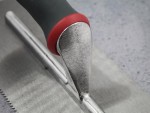 A Faithfull notched tile trowel with 3mm notches for combing adhesive on floors and walls, ensuring even coverage beneath tiles.