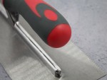 A Faithfull notched tile trowel with 3mm notches for combing adhesive on floors and walls, ensuring even coverage beneath tiles.
