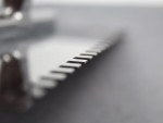 A Faithfull notched tile trowel with 6mm notches for combing adhesive on floors and walls, ensuring even coverage beneath tiles.