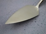 A Faithfull trowel with a polished steel blade and an ergonomic handle, for applying and finishing mortar, plaster, and adhesive.