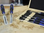 A hardened steel chisel with a bevelled cutting edge and a square-section body, for cutting stone, brick, or timber.