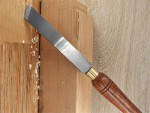 A hardened steel chisel with a bevelled cutting edge and a square-section body, for cutting stone, brick, or timber.