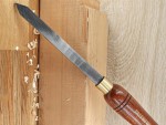 A hardened steel chisel with a bevelled cutting edge and a square-section body, for cutting stone, brick, or timber.