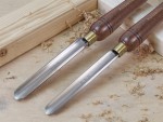 A hardened steel chisel with a bevelled cutting edge and a square-section body, for cutting stone, brick, or timber.