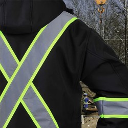 Man on construction site wearing enhanced visibility crew neck. 