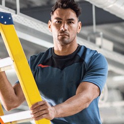 Man stepping on ladder wearing Portwest workwear clothing